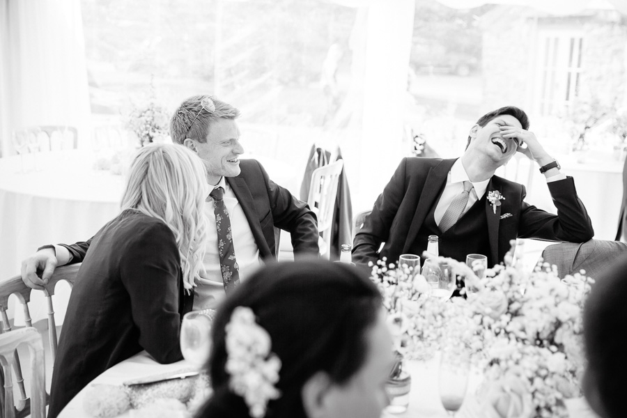 Groom laughing with guests