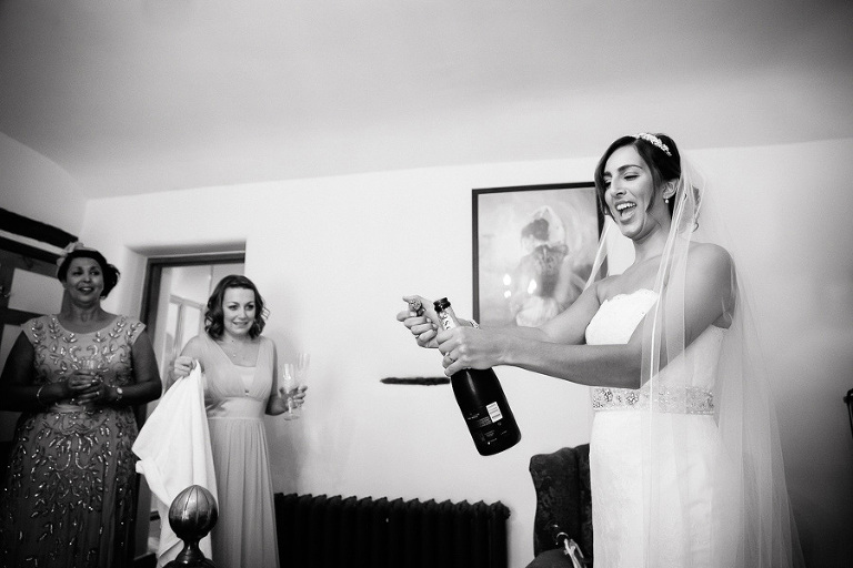 bride opening champagne