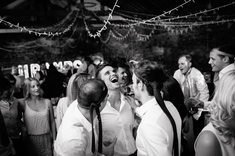 Groom laughing with groomsmen